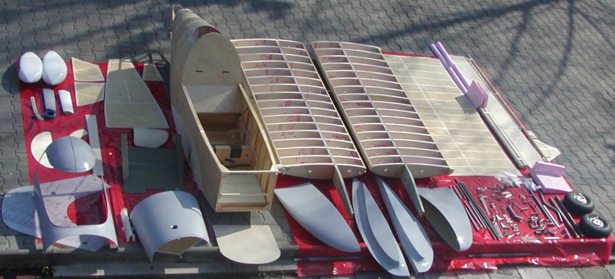 An SD-1 TGC 51% kit laid out: plywood-covered fuselage, wing structures with ribs, moulded composite parts, control surfaces and hardware