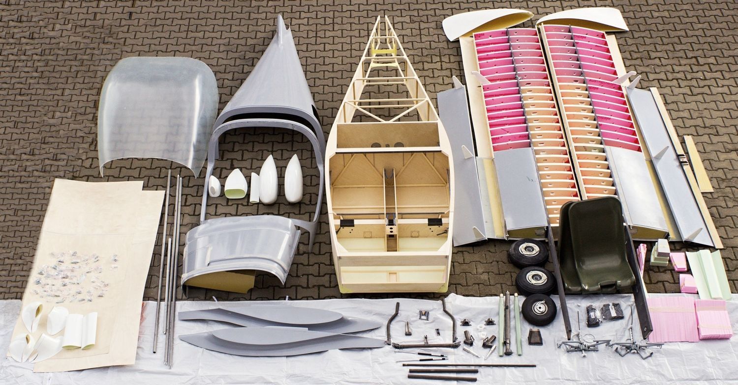 An SD-2 kit laid out: fuselage structure, wing panels with ribs, moulded composite parts, undercarriage and hardware